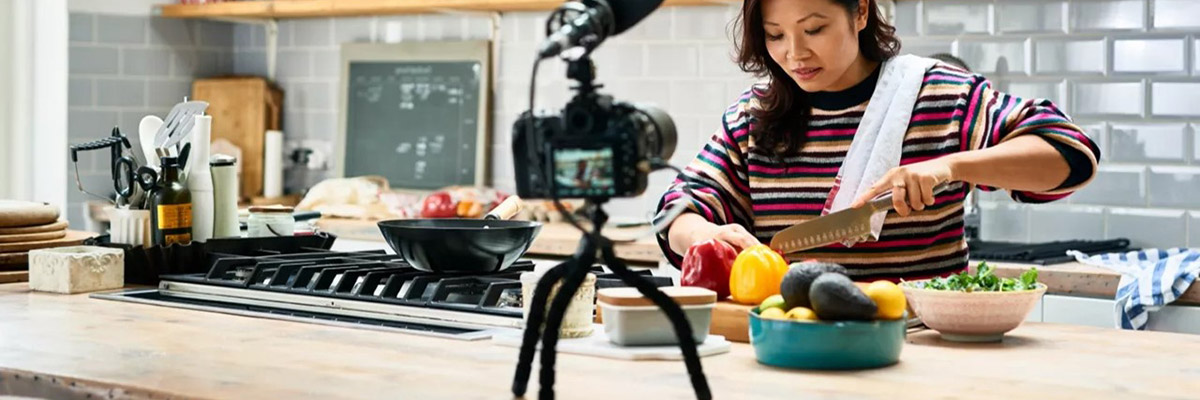 A woman live streaming her meal preparation in the kitchen